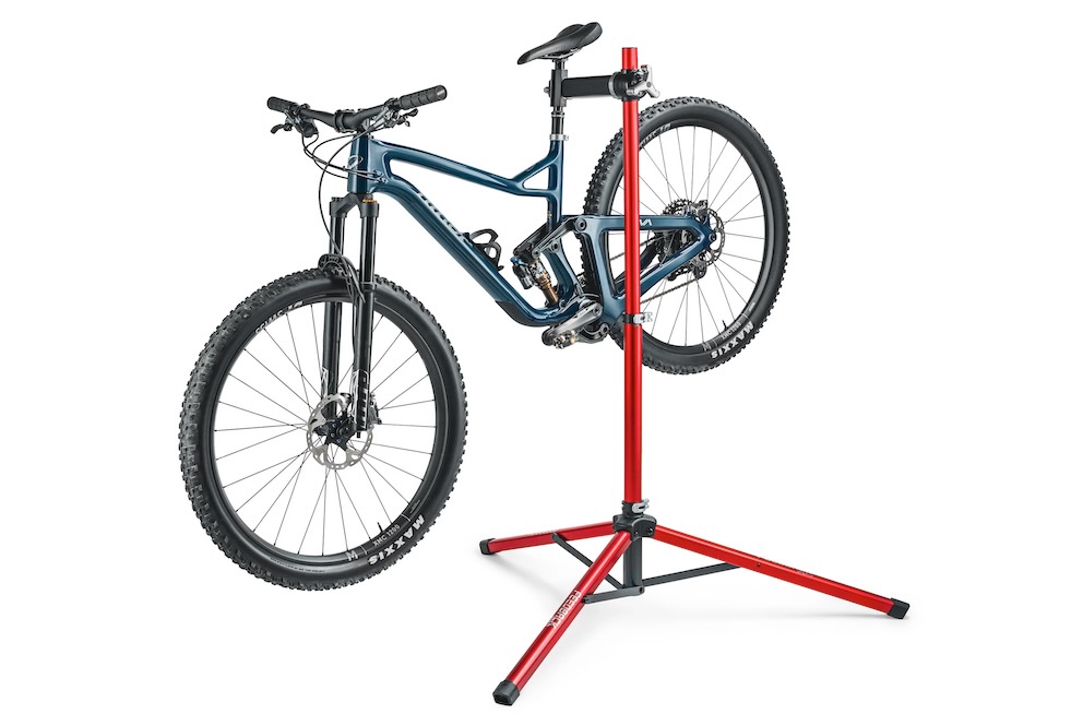 Studio image of the Pro Ultralight Repair Stand holding a mountain bike.