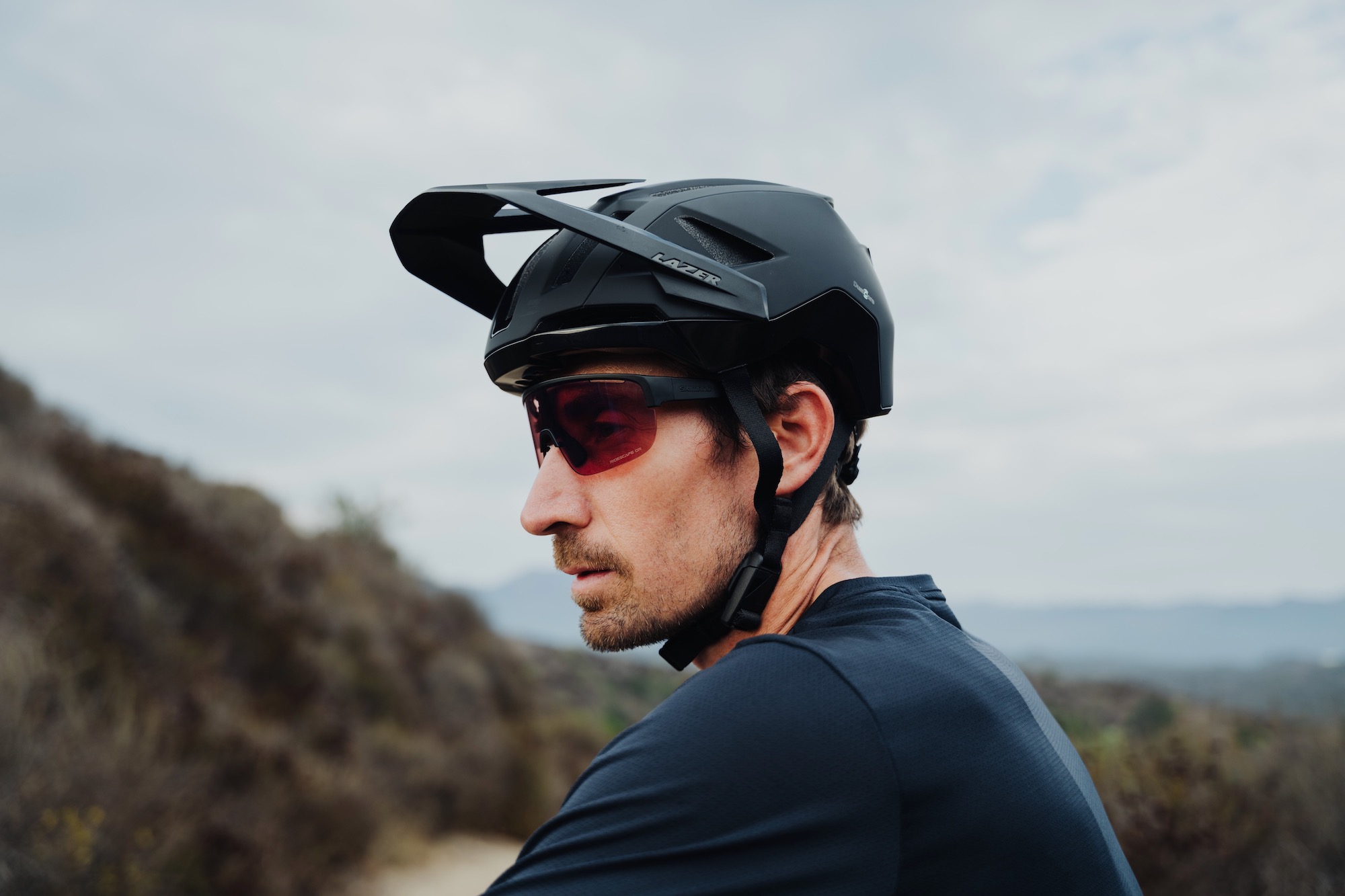 A man wearing the new Lazer Impala KinetiCore helmet in black