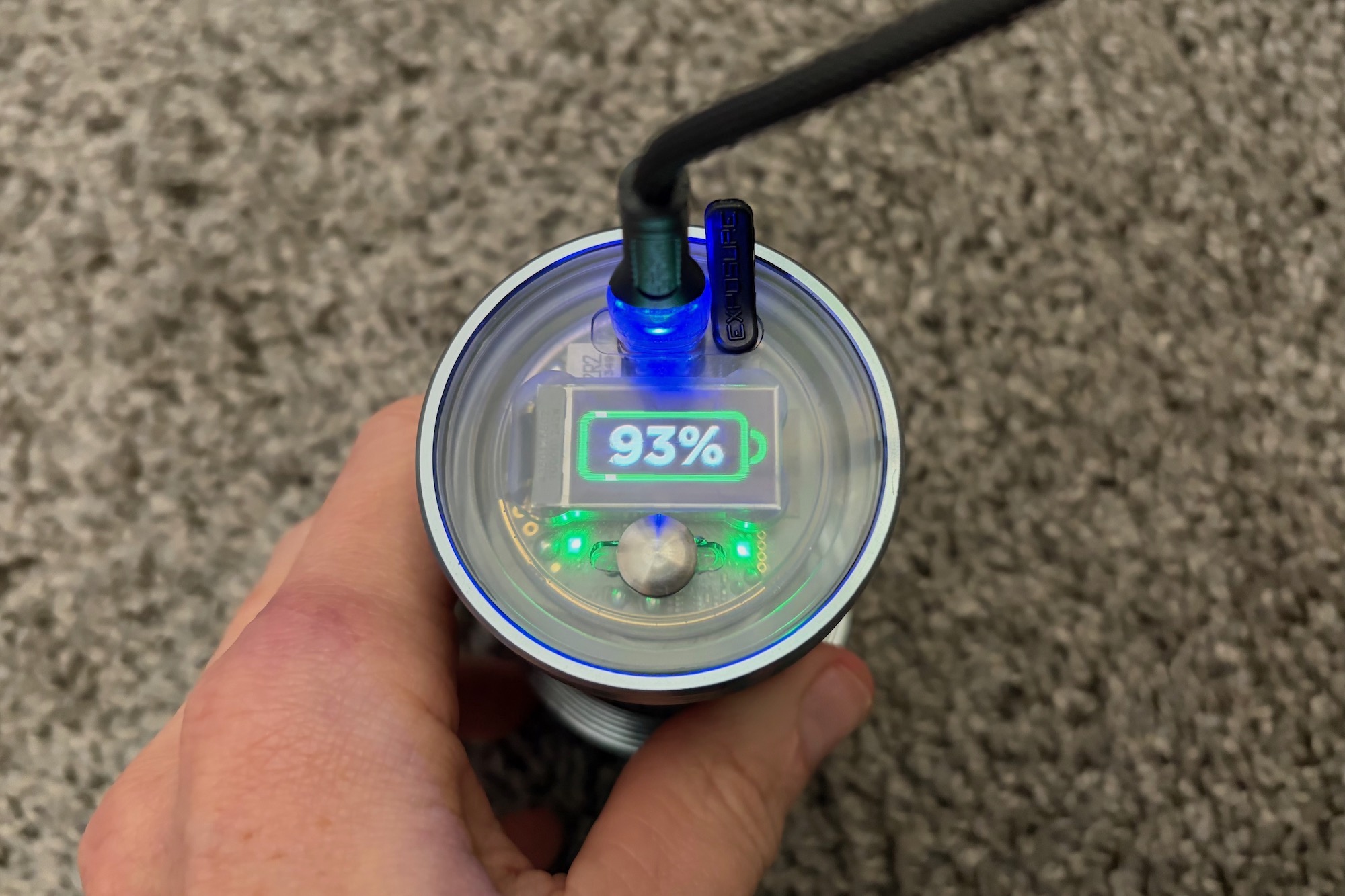 the screen on the back of the six-pack 15 showing the battery percentage while charging