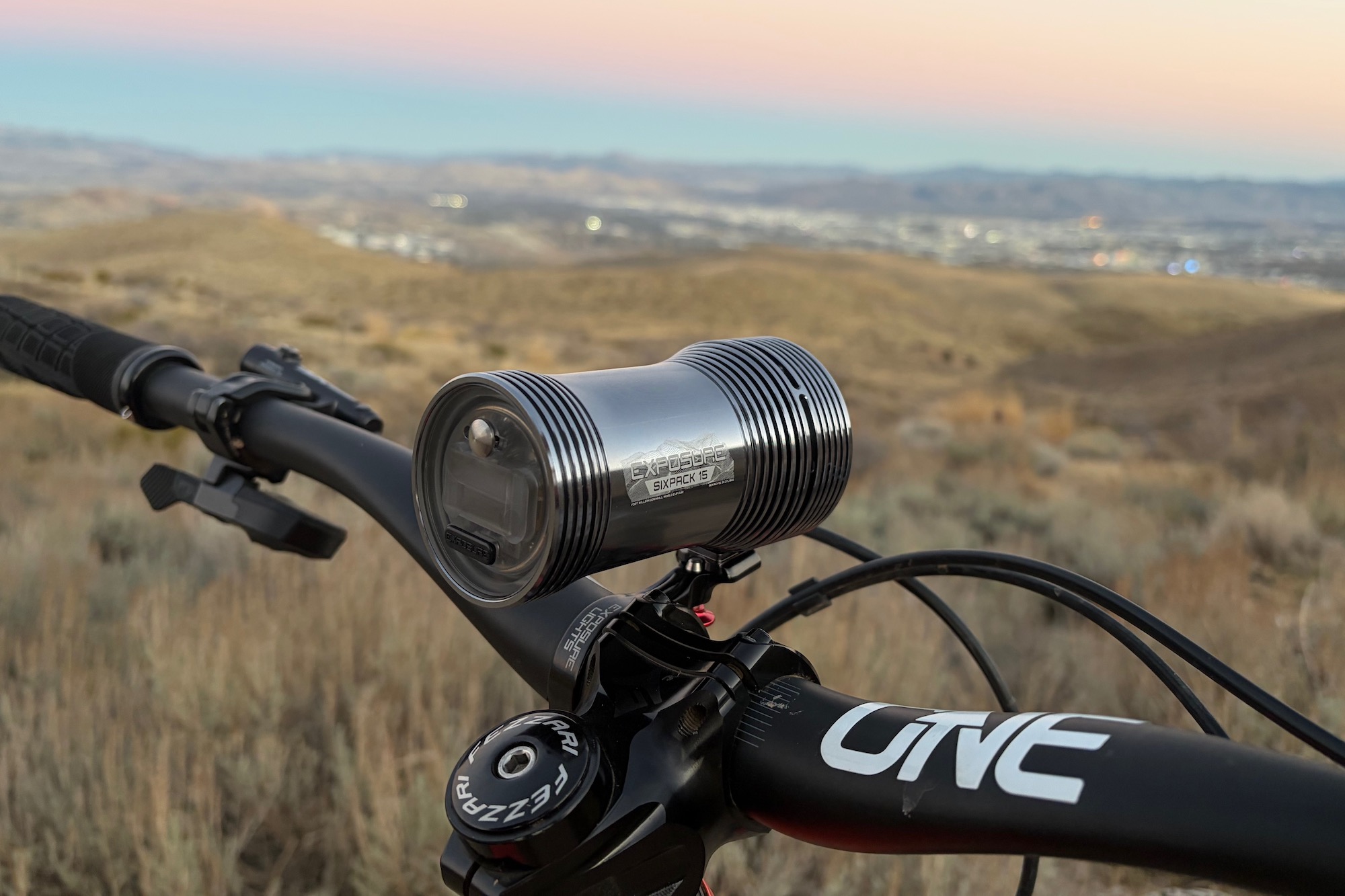 the handlebar mount for the Six-Pack 15 attached to a mountain bike handlebar out on a ride with the light attached