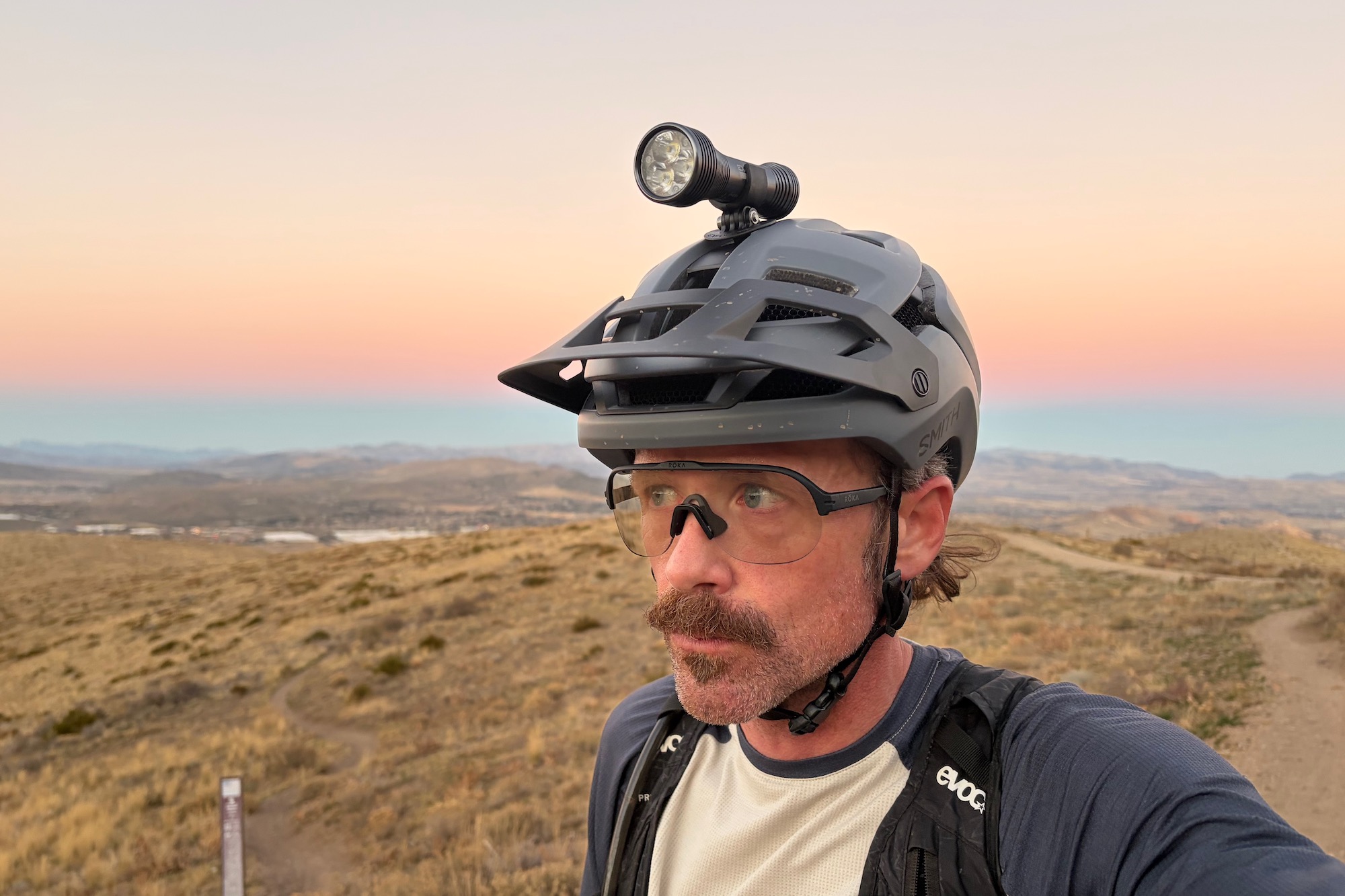 wearing a helmet with the Exposure Zenith mounted on it after sunset.