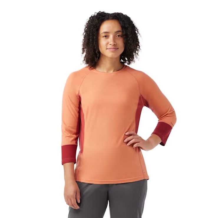 studio image of a feamle wearing the Smartwool 3/4 sleeve mtb jersey