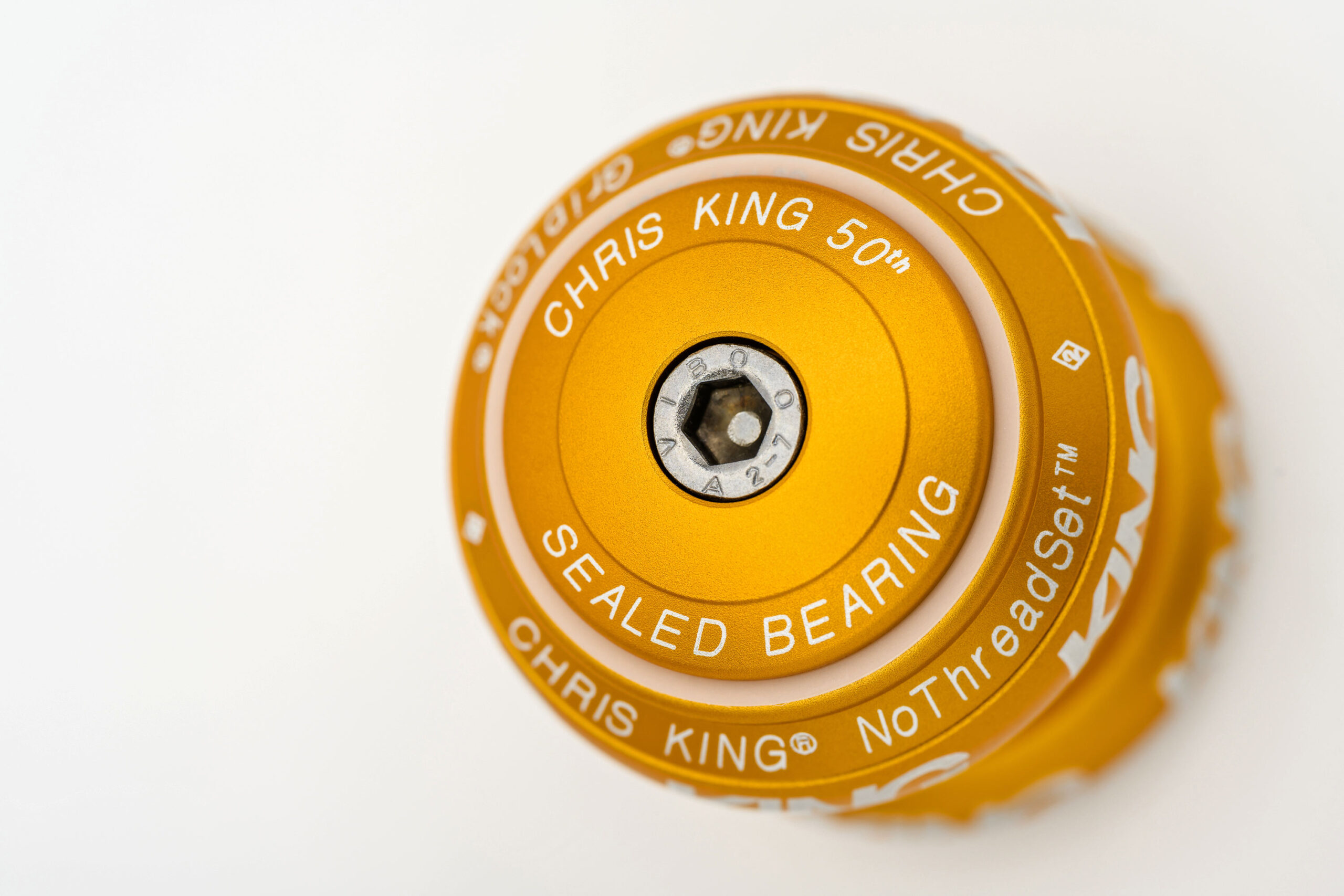 2026 Chris King 50th anniversary celebrated in limited Matte Gold honey sweetness, headset stem cap detail