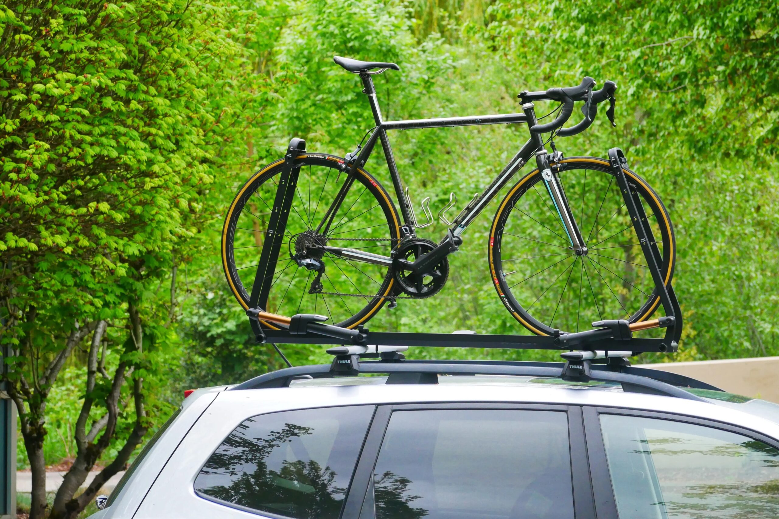 A boutique road bike mounted in the Kuat Piston SR roof bike rack to demonstrate loading height