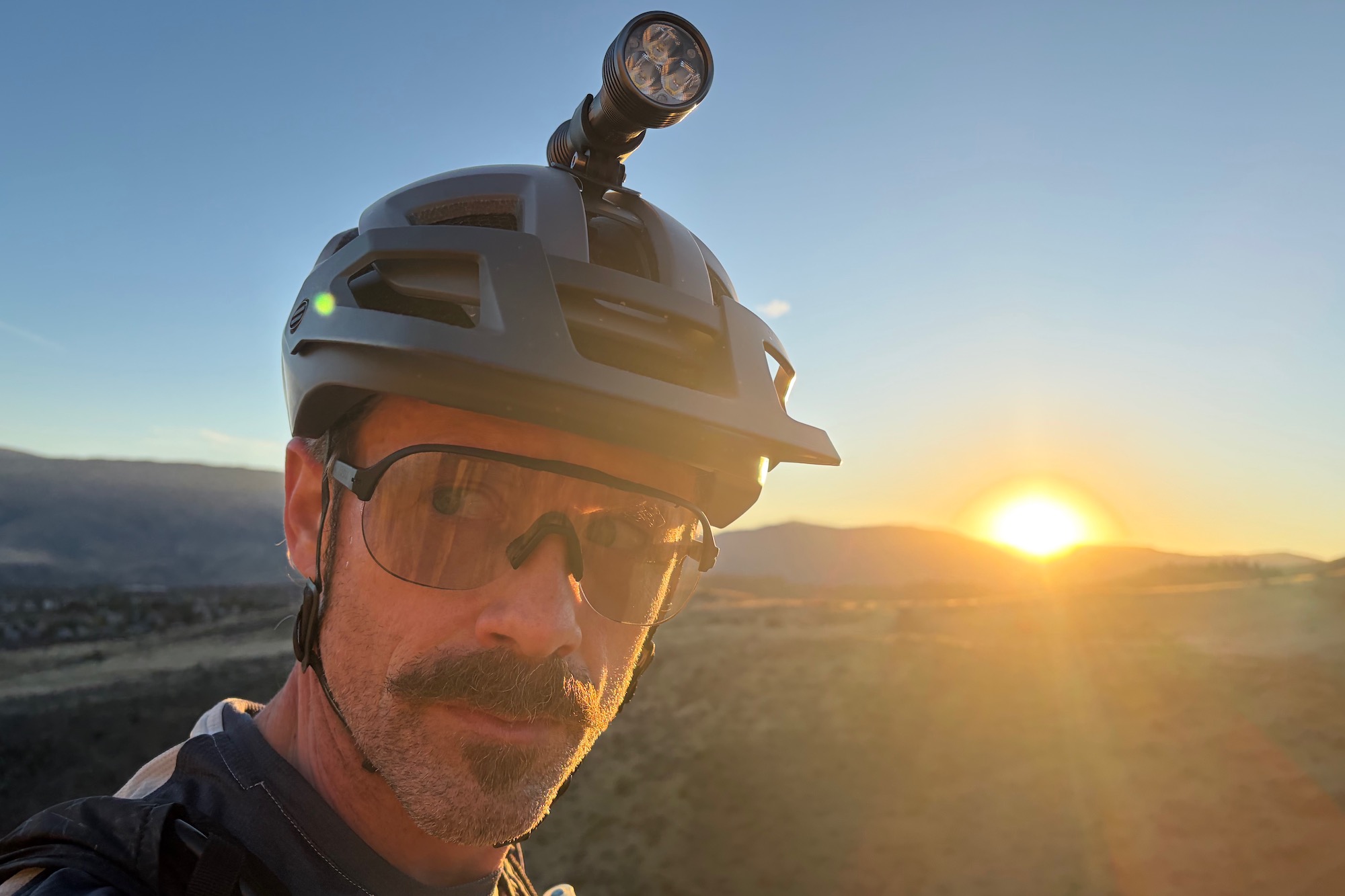 wearing the san remo sunglasses with the sun setting in the background