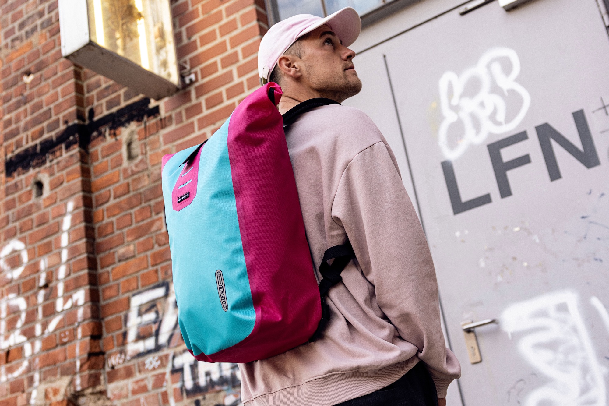 A man wearing the Velocity Lite backpack in Cyber Blue