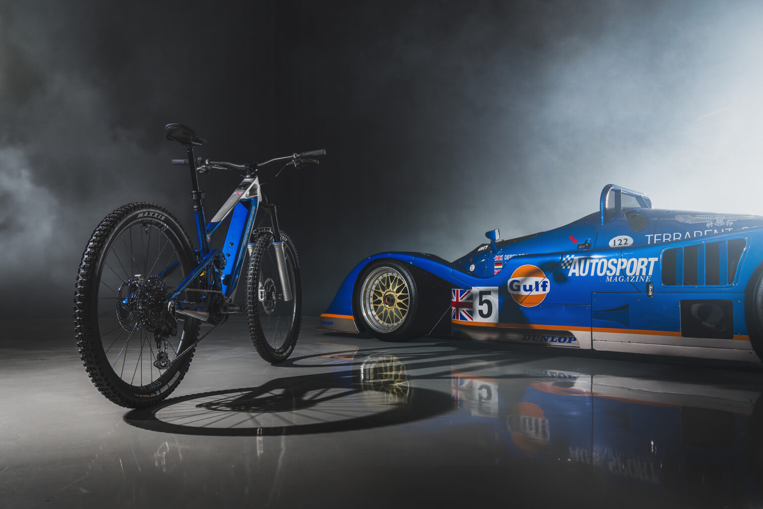 a shot of the new Crafty from behind next to a race car