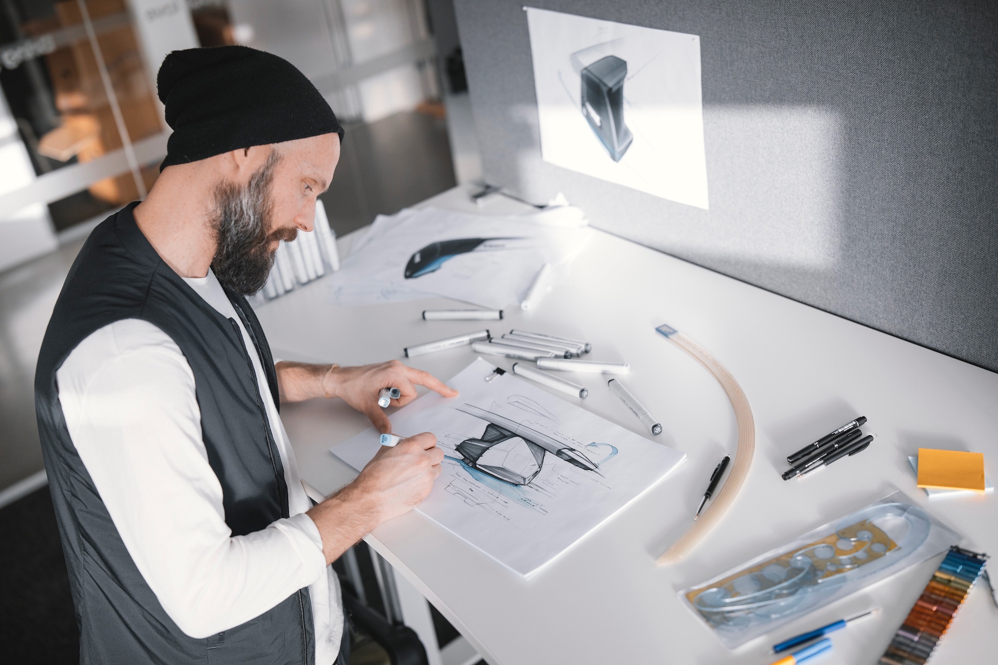 A Thule designer sketching a crossbar for a roof mounted rack