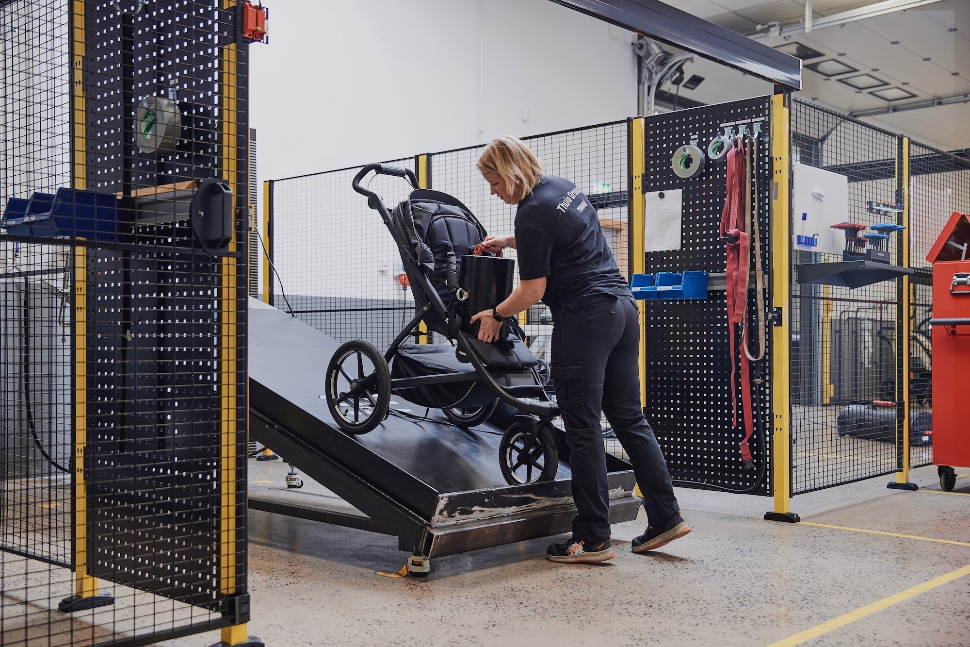 A Thule test engineer working with a stroller in the Thule Test Center.