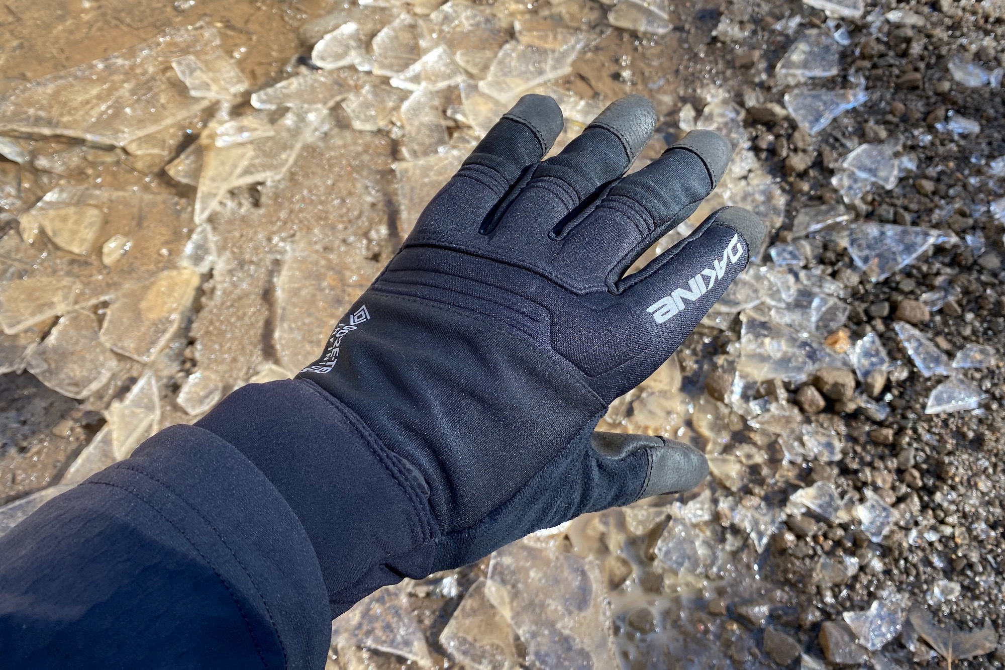 Wearing the dakine white knuckle gloves on a test ride with broken ice in the background.