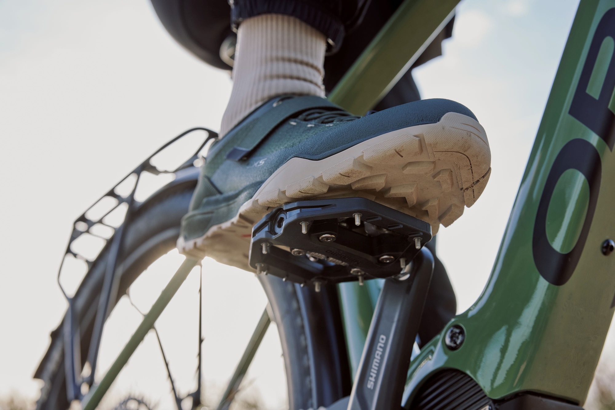 a foot resting on the PD-EH510 hybrid pedals and clipped in to the SPD binding.