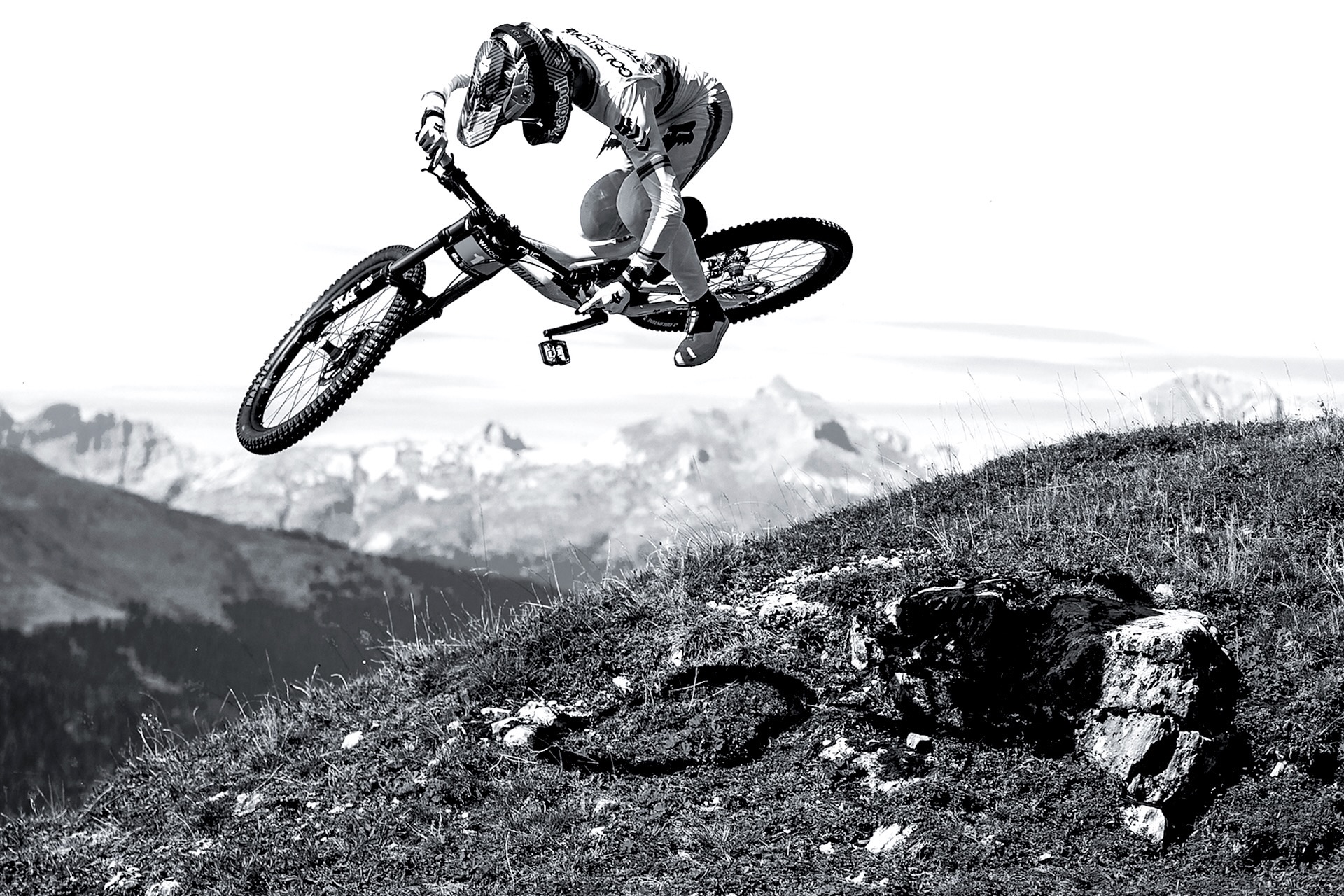 Jackson Goldstone jumping on a downhill bike using the OneUp Goldstone Grips.