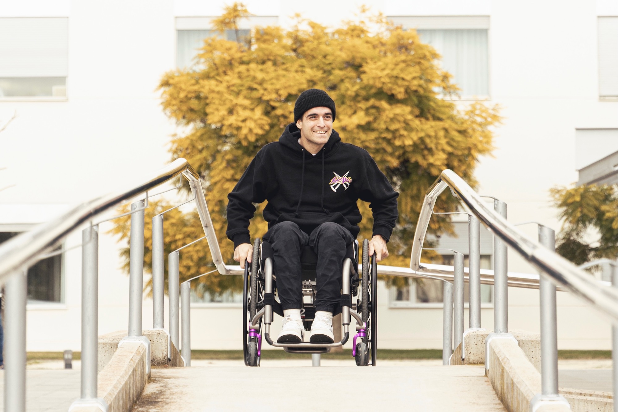 Adolf Silva in a wheelchair smiling