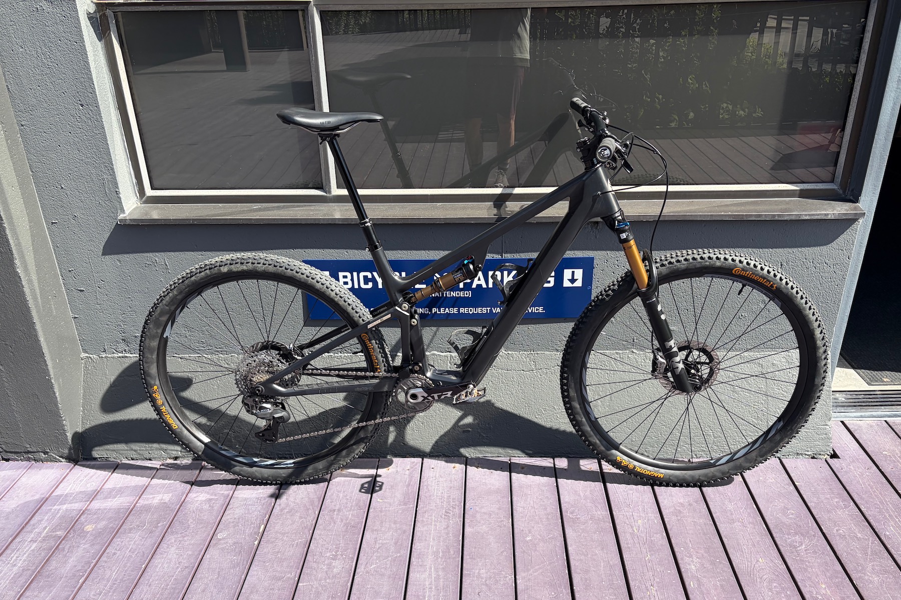 The Ibis Ripley SL test bike leaning against a wall outside the Ibis Demo Center.