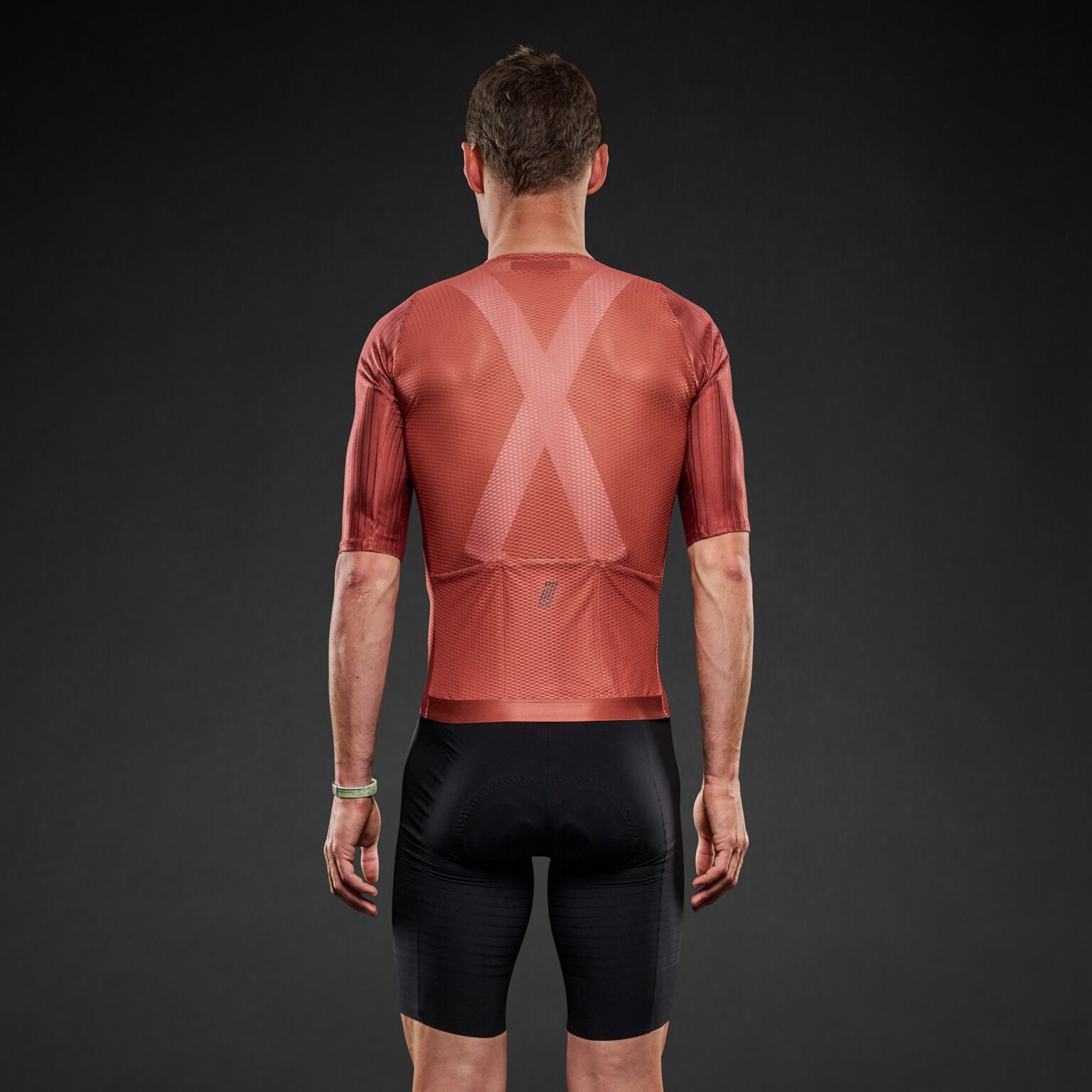 studio image of a man wearing the Pi Black mesh jersey, viewed from behind.