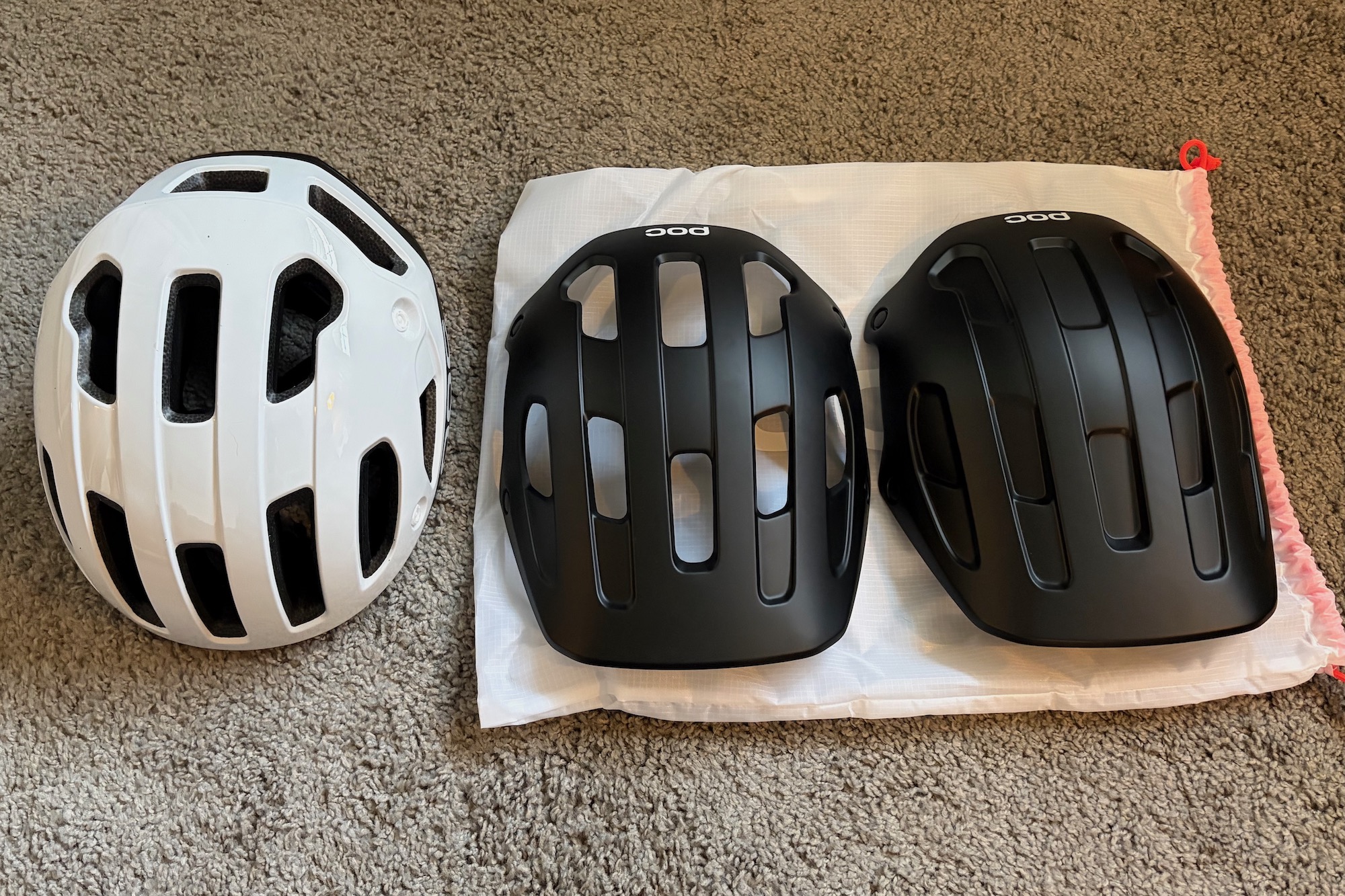 the POC Cularis Pure helmet with both of the interchangeable covers next to it.
