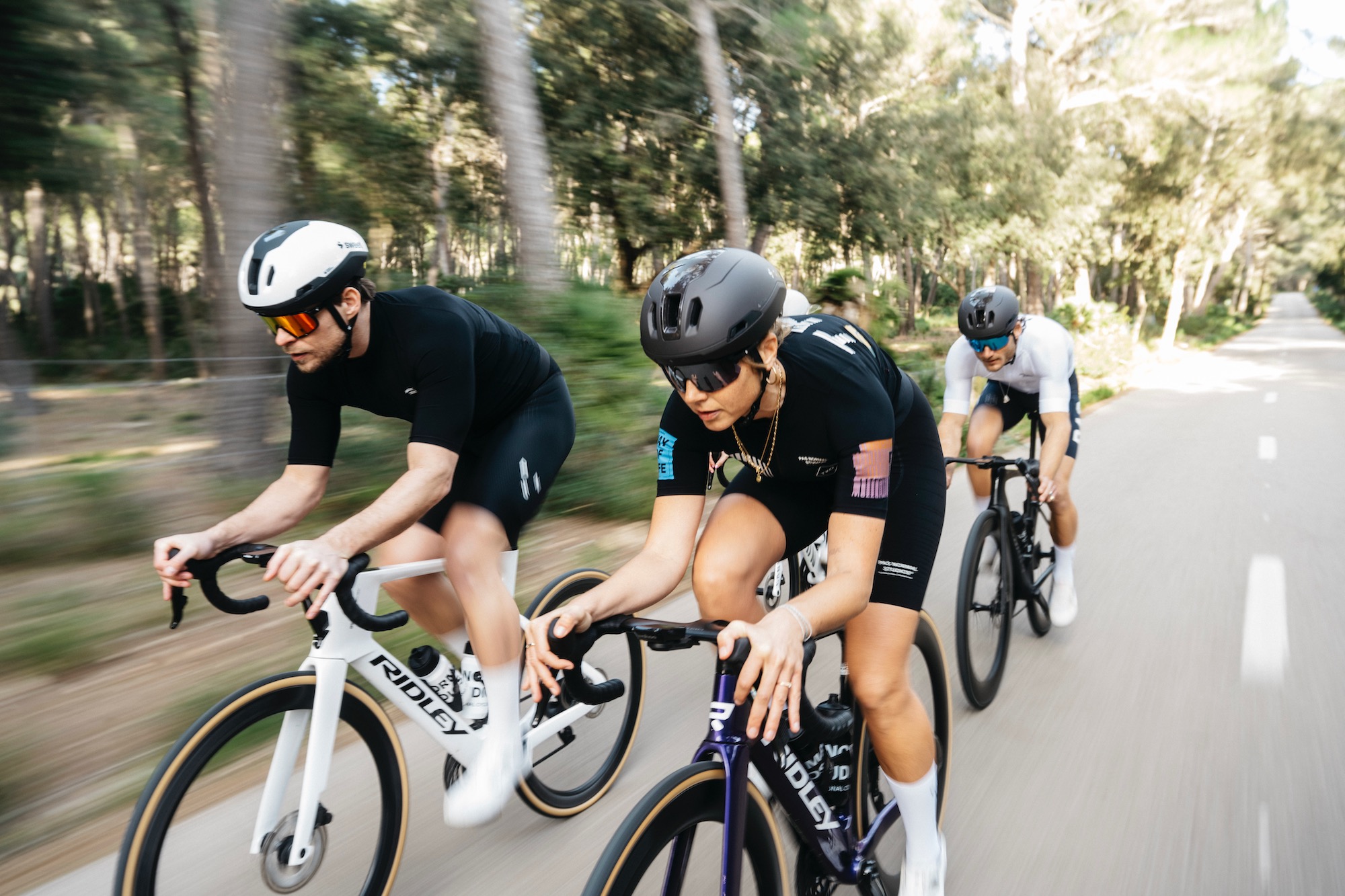 several riders on road bikes wearing the Sweet Protection Tucker III 2Vi Mips helmet.