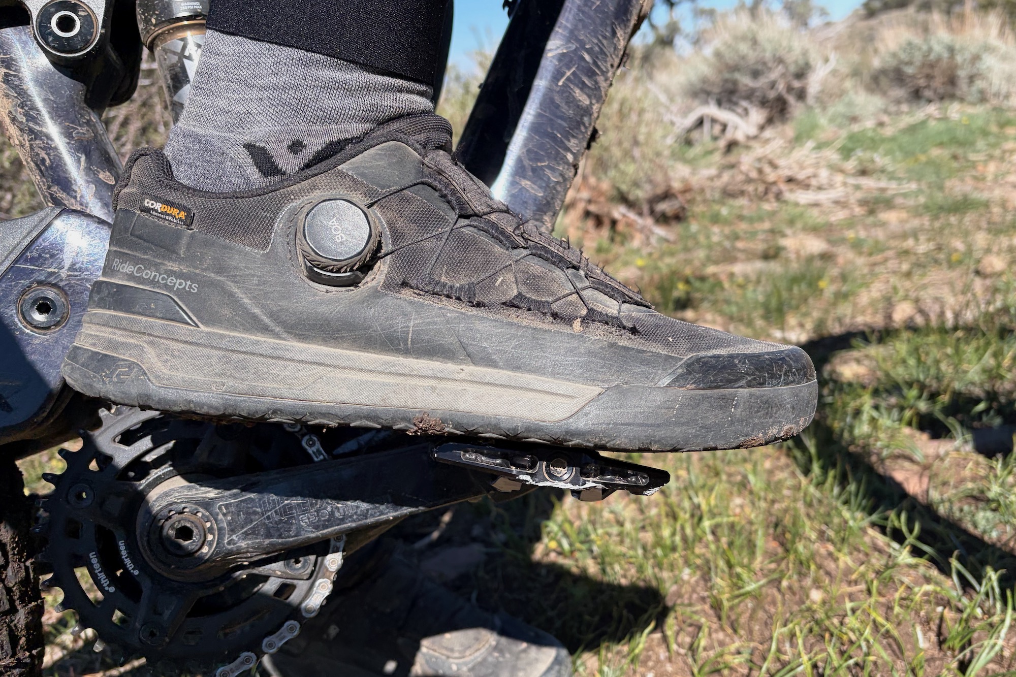 a shoe clipped in to the Wolf Tooth SHIFT pedal to show the sole contact from the side.