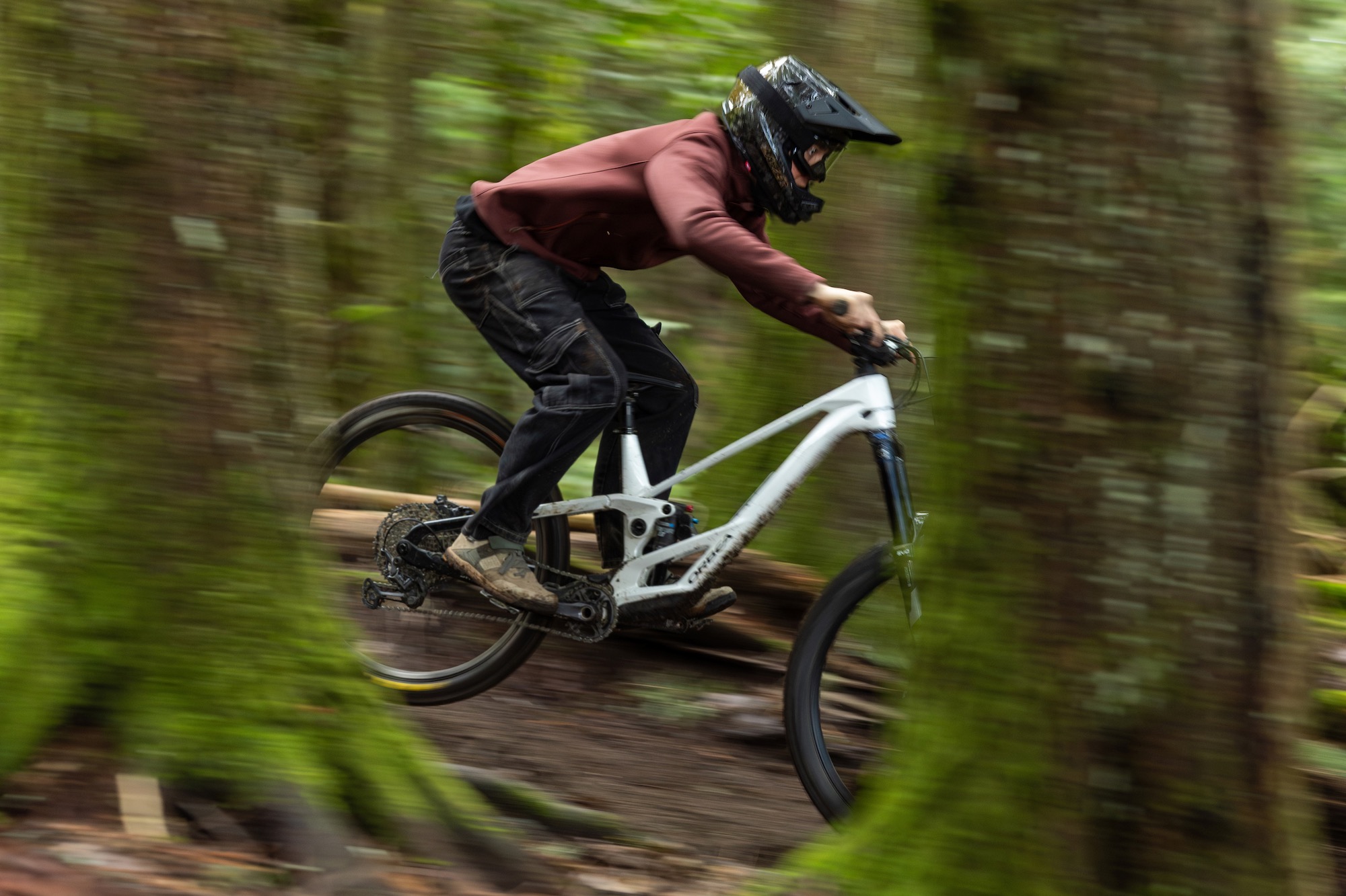 a person riding a bike through the forest while wearing the Lazer A-Line KinetiCore helmet