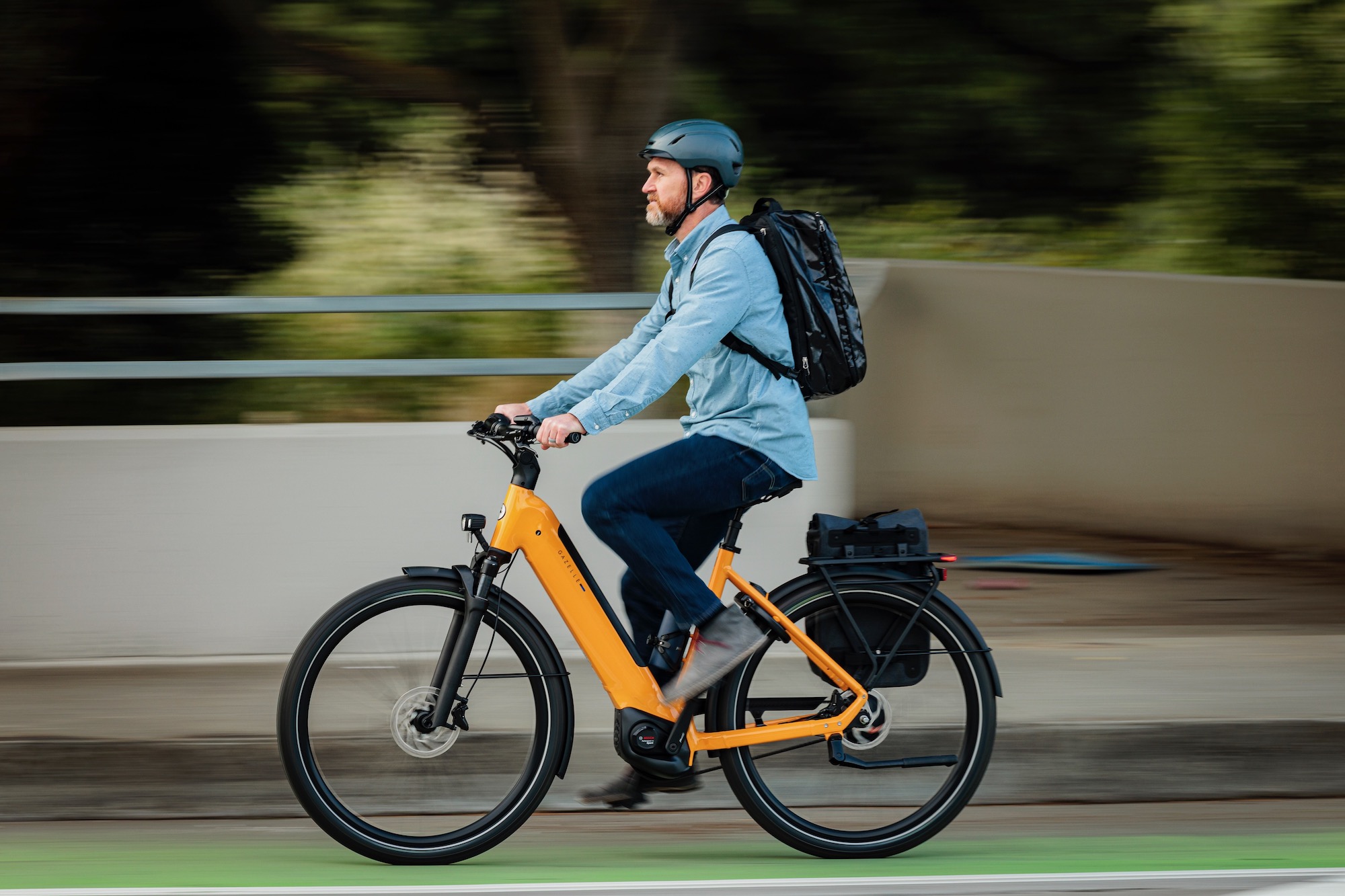 a man riding a Gazelle Ultimate commuter bike on a city street.