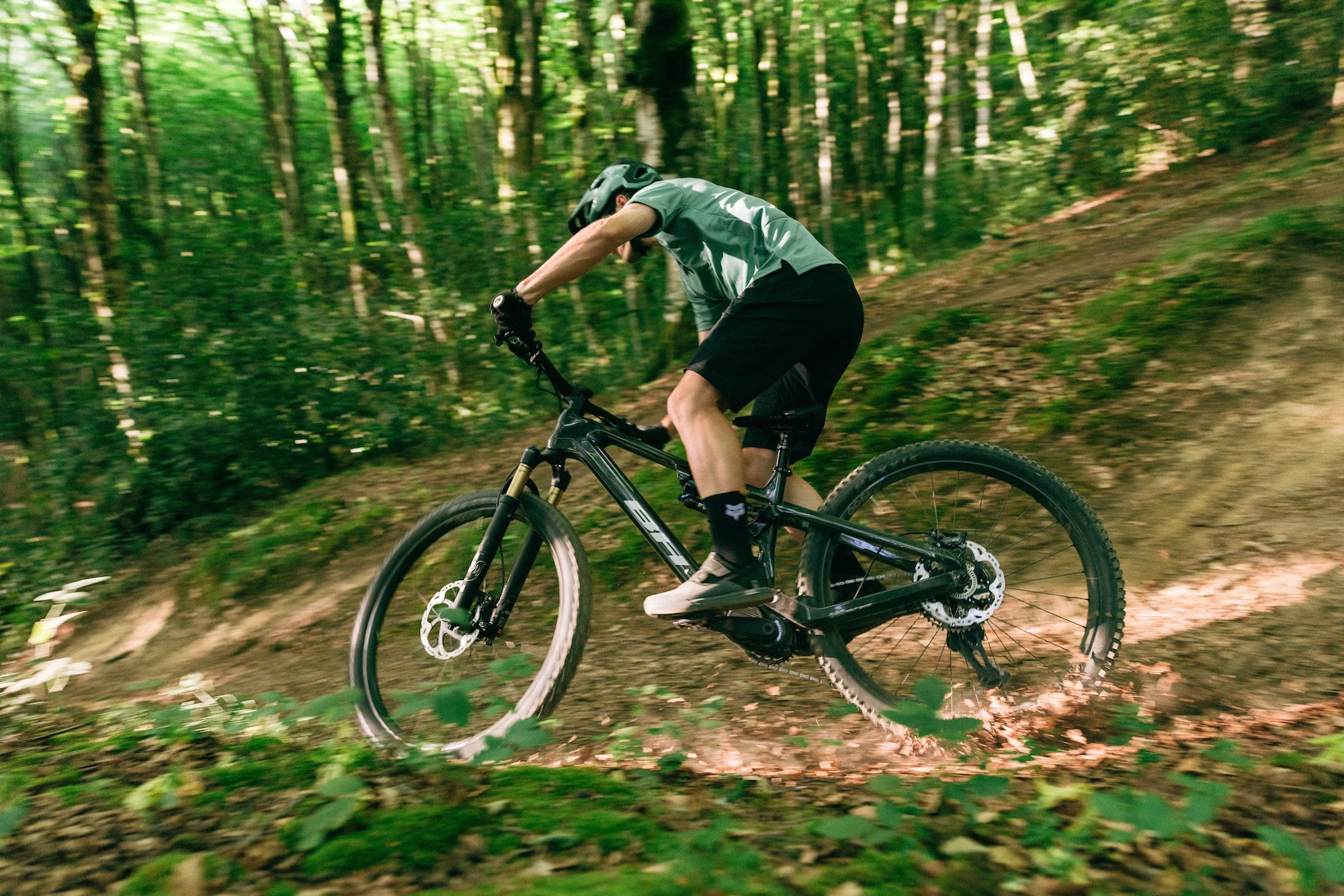 a mountain biker going around a turn on the BH iLynx+ DL Trail eMTB