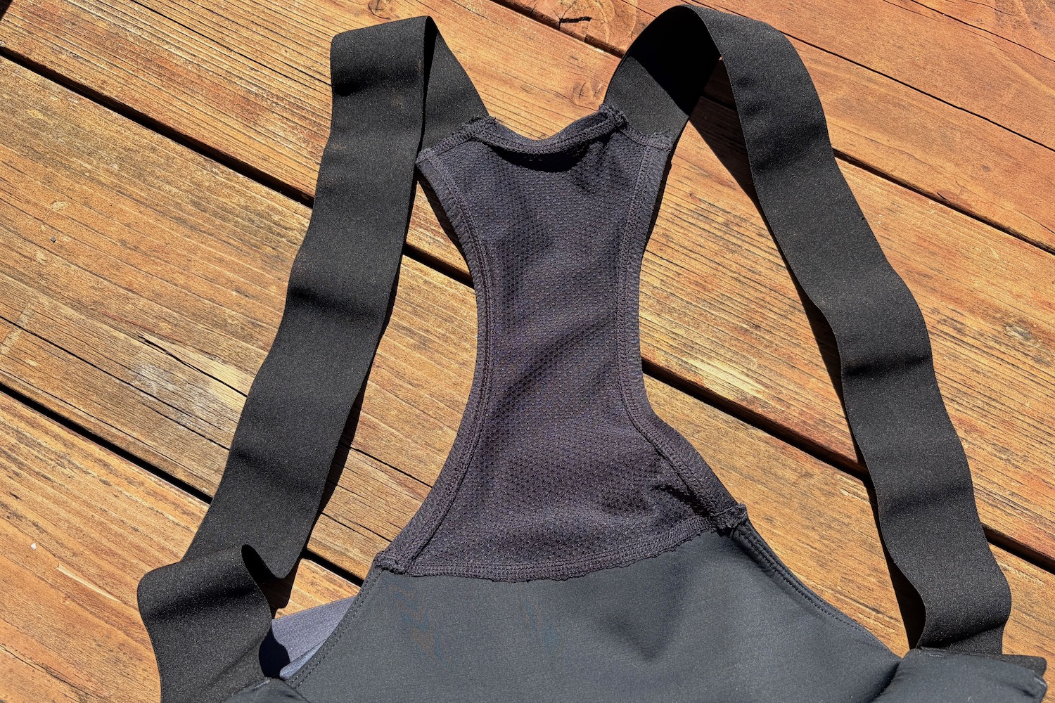 the straps and back panel of the Backcountry Liner Bib Shorts