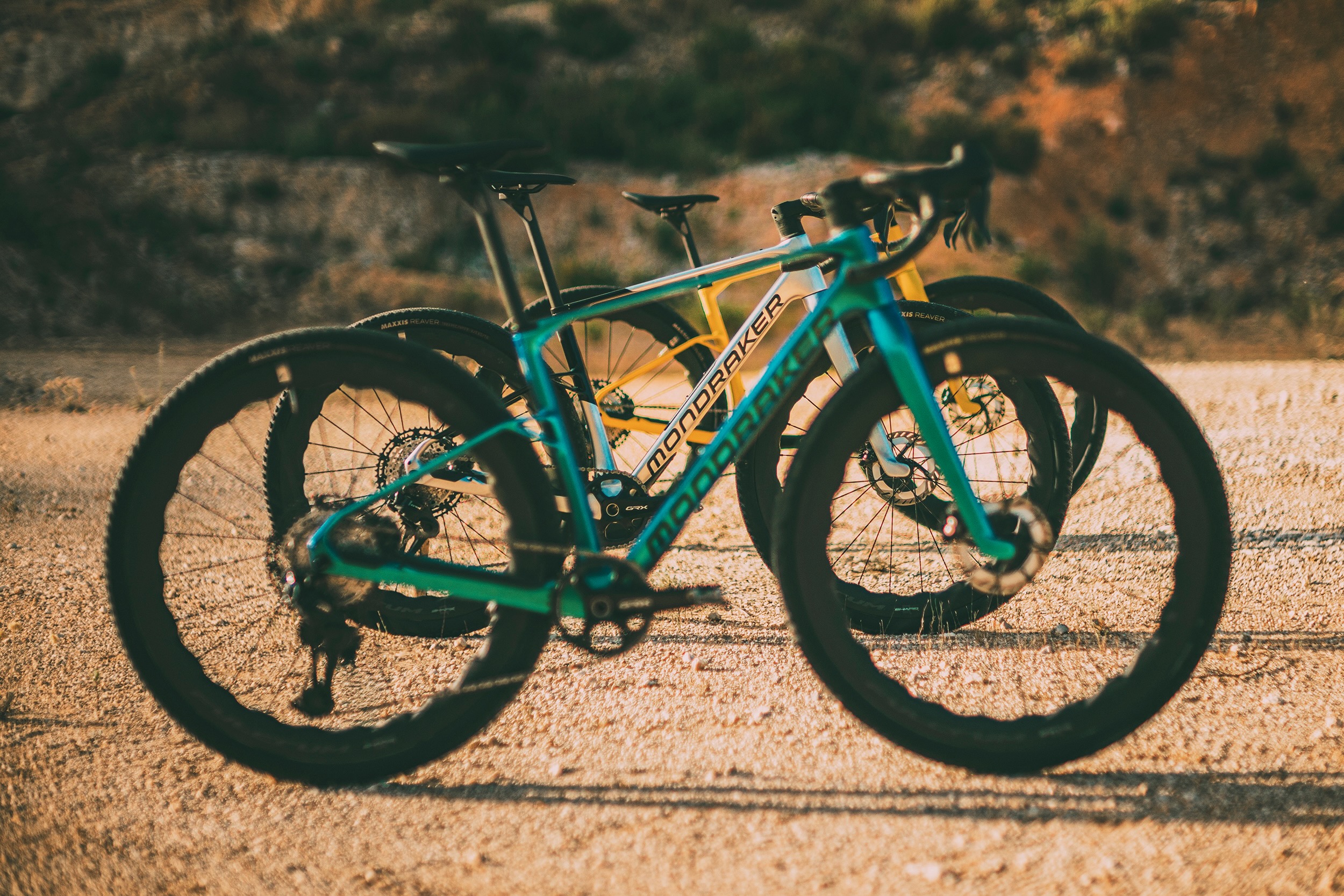 three mondraker arid gravel bikes lined up next to each to show some of the different colors.