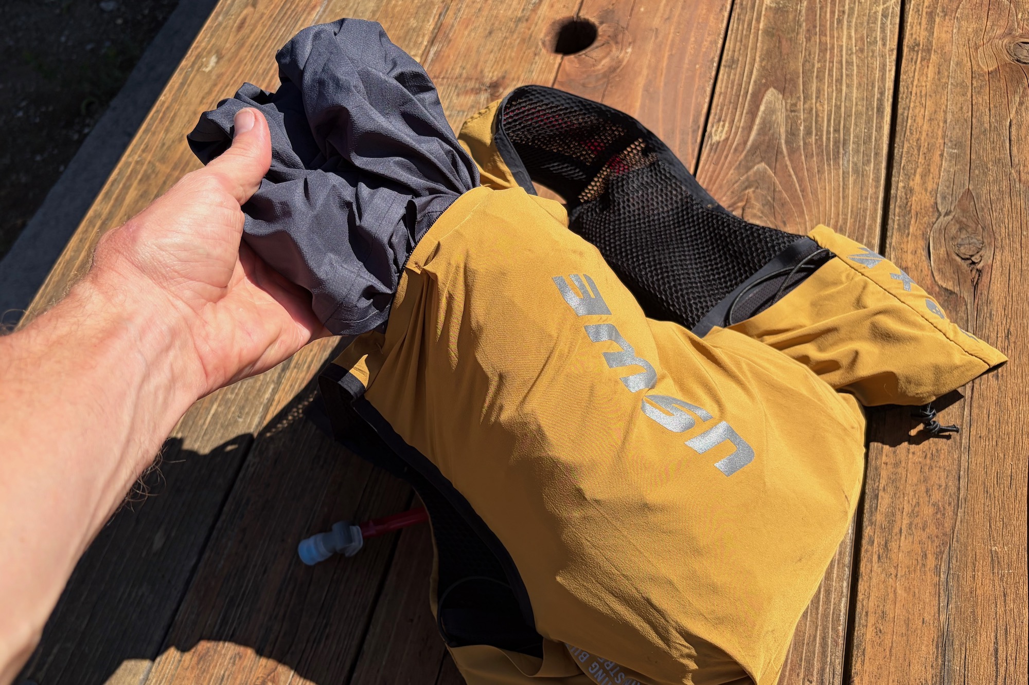 pulling a jacket out of the top zip on the USWE VST