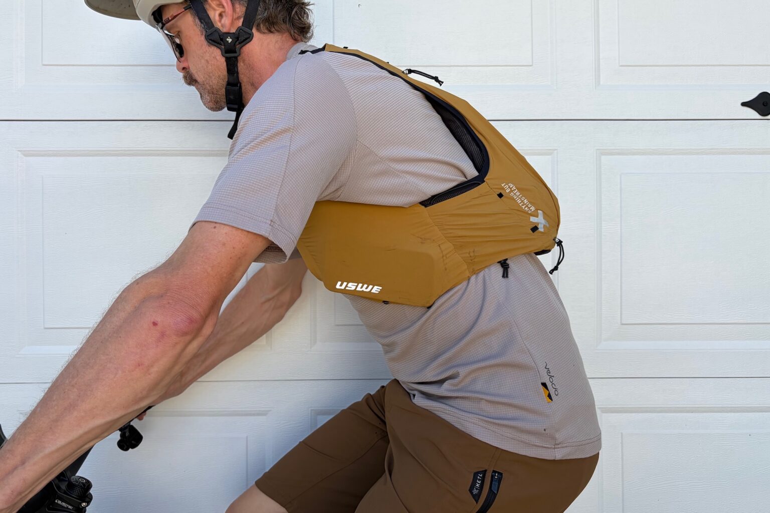 wearing the USWE VST in the seated pedling position on the bike with no jacket