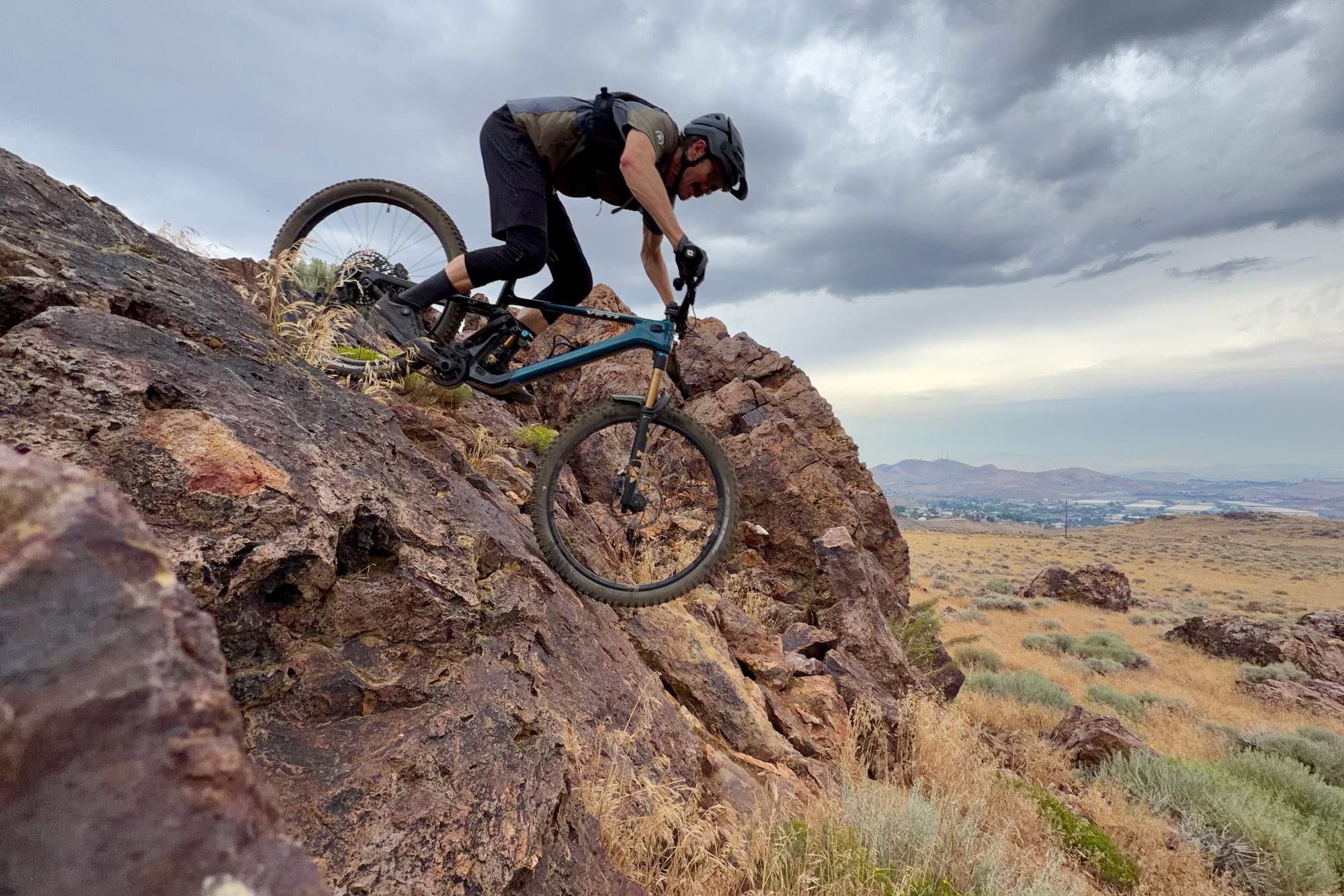 riding the Yeti LT ovr a steep rock roll