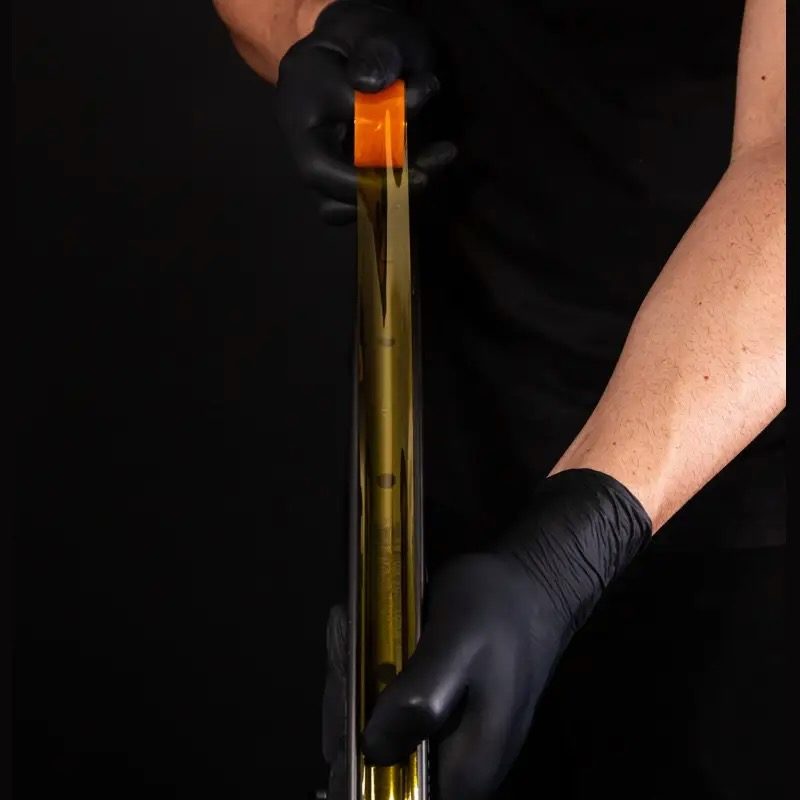 studio image of a person installing absoluteBLACK tubeless tape